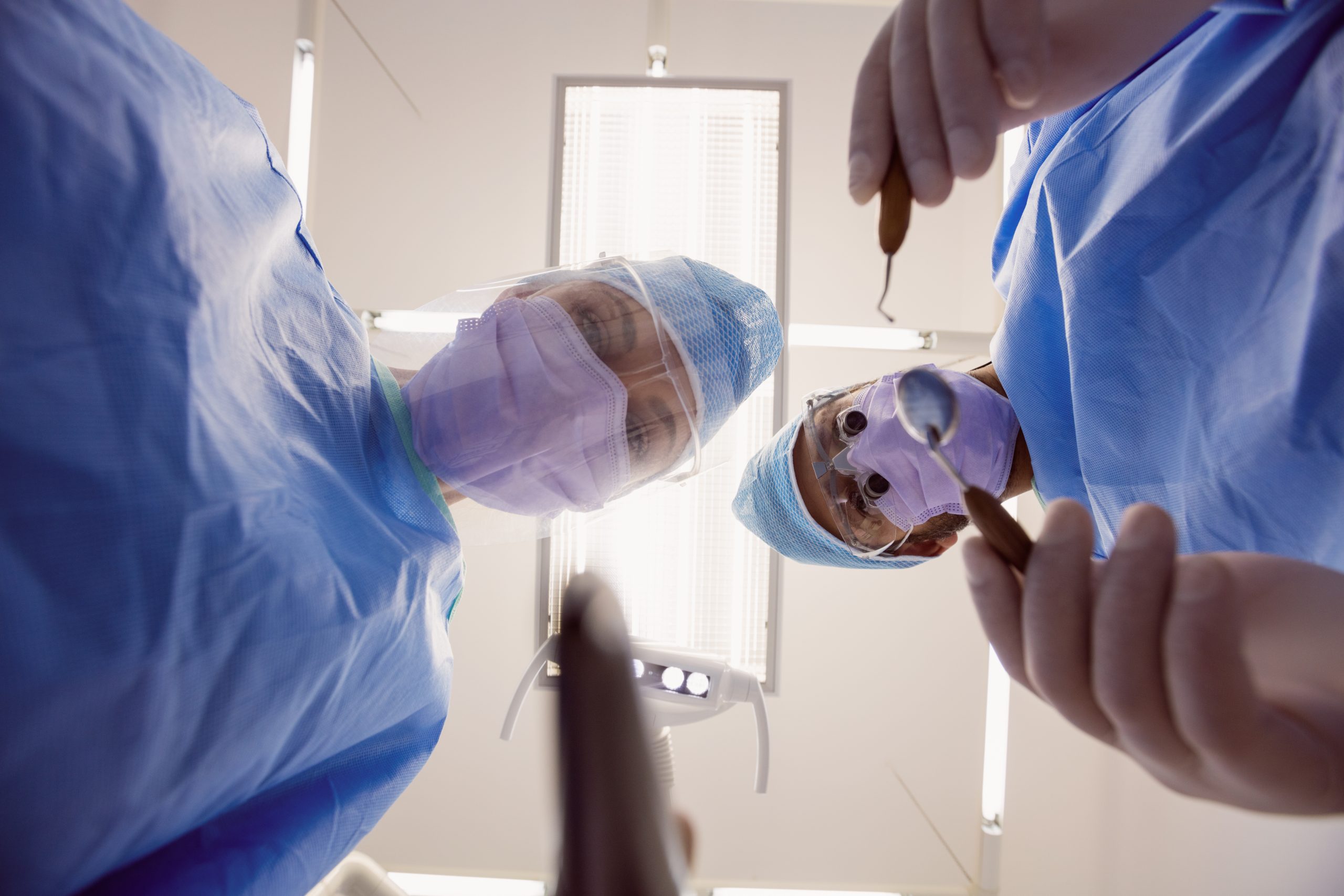 close up of dentists holding dental tools at dental clinic